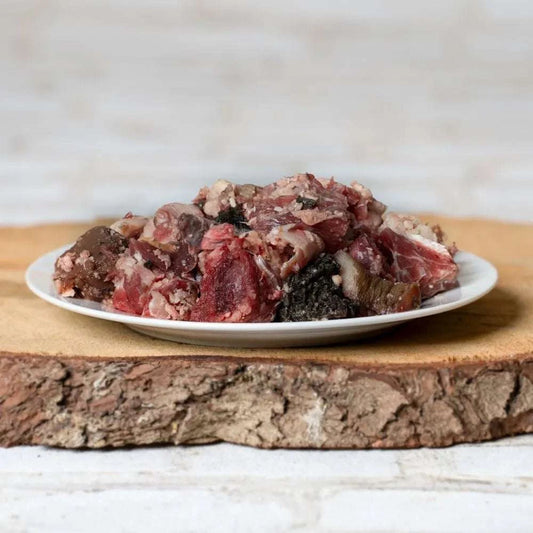 BARF-Fleischmenü vom Rind mit Knochenmus auf Teller, geeignet für Hunde ab 15 kg.