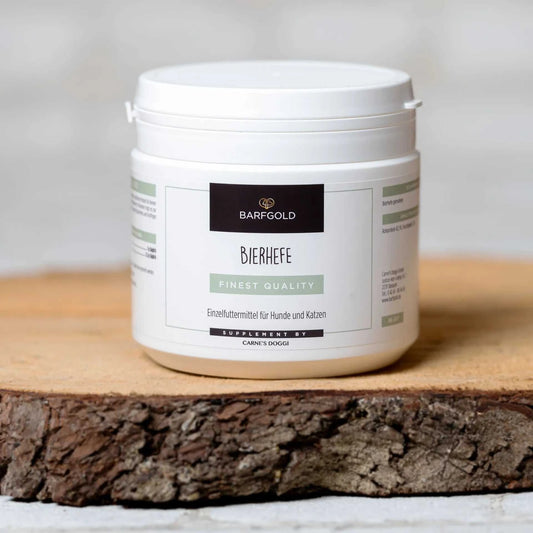 Bierhefe 350 g Dose für Hunde und Katzen auf Holzbrett, reich an B-Vitaminen, in Pulverform für glänzendes Fell.