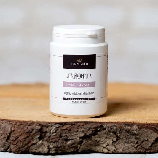 Leberkomplex 100 g Dose für Hunde auf Holzbrett, unterstützt die natürliche Leberfunktion mit Kräutermischung.