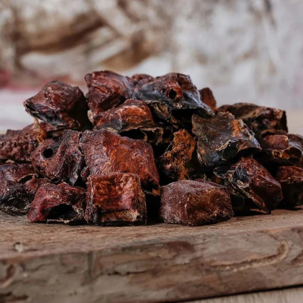 Pferde-Lungenwürfel auf Holzbrett als Belohnung für Hunde und Katzen, geeignet für allergische Tiere.